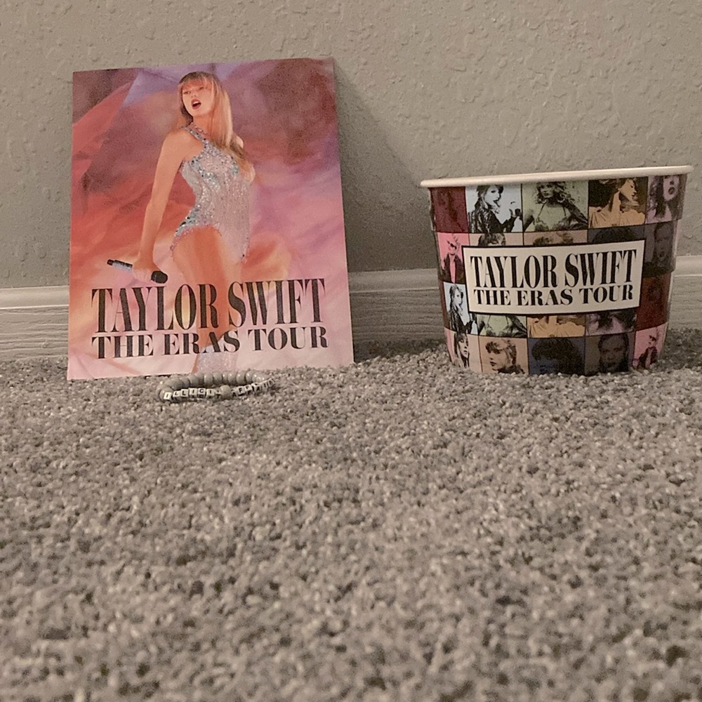 Taylor Swift Eras Tour 2023 collectible popcorn bucket with bracelet and poster.